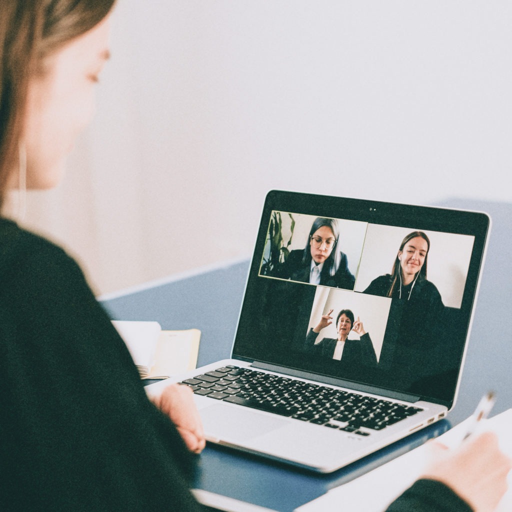 Photo of three women in a virtual meeting.